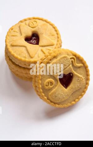 pile of Jammie Dodgers raspberry flavour biscuits tis the season to be jammie showing Christmas stocking and star designs isolated on white background Stock Photo