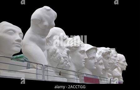 Plaster busts of some historical persons and ancient greek mythological characters isolated on black Stock Photo