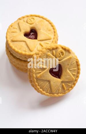 pile of Jammie Dodgers raspberry flavour biscuits tis the season to be jammie showing star design isolated on white background Stock Photo