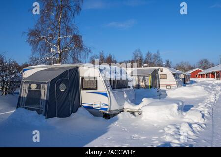 Campsite with snowy and icy caravans in winter Stock Photo