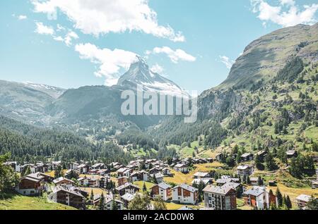 Picturesque Alpine village Zermatt in Switzerland in the summer season. Famous Matterhorn mountain in the background. Typical Alpine mountain huts. Swiss Alps, Alpine landscapes. Stock Photo