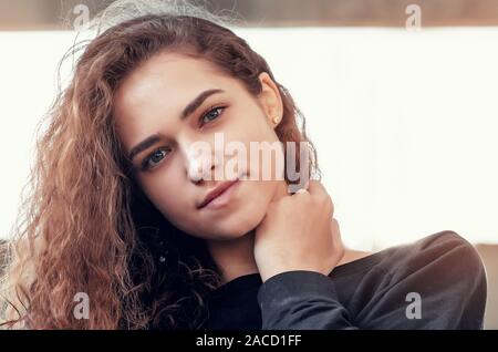 Sunny portrait of a beautiful curly girl, look at the camera. Stock Photo