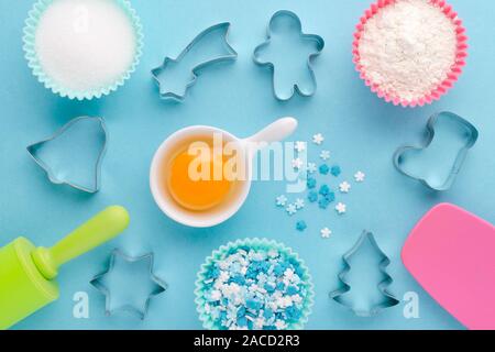 ingredients and cookie cutter on blue background, flat lay Stock Photo