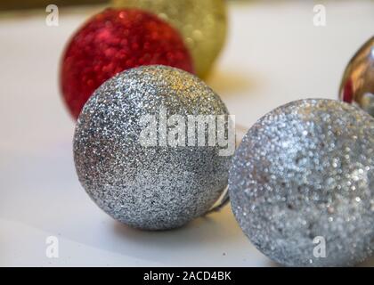 Close-up of shiny christmas toys, colorful balls covered in glitter, selective focus, new year holiday decorations Stock Photo