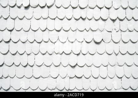 old wooden shingles siding painted white - background texture pattern with copyspace Stock Photo