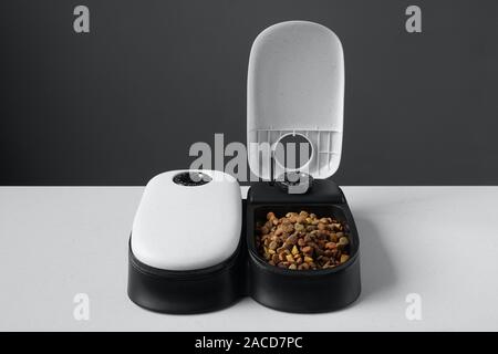 automatic feeder. Automatic pet food dispenser on the floor of the