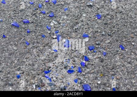Blue broken glass on the asphalt Stock Photo