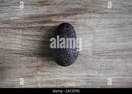 overhead view of hass avocado fruit on rustic wooden table Stock Photo