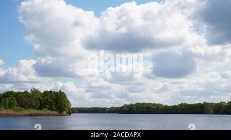 dramatic clouds over bathing lake in Germany Stock Photo
