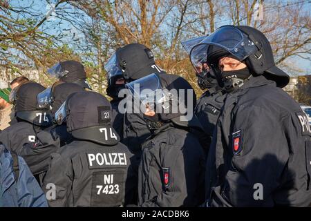 Braunschweig, Germany, November 30., 2019: Masked policemen with mask and helmet in black uniforms Stock Photo