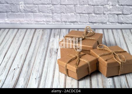 Three cardboard boxes taped on a wooden table. Mail, courier or delivery service concept. Copy space Stock Photo