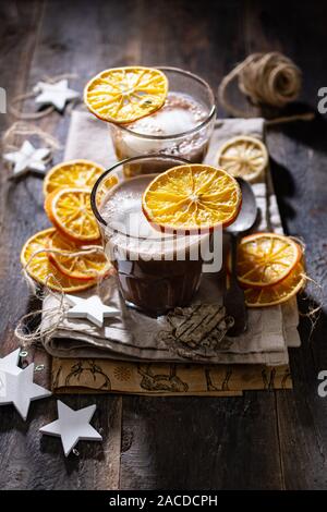 Hot chocolate on a cold winter day.Healthy food and drink.Delicious homemade dessert with dried orange Stock Photo