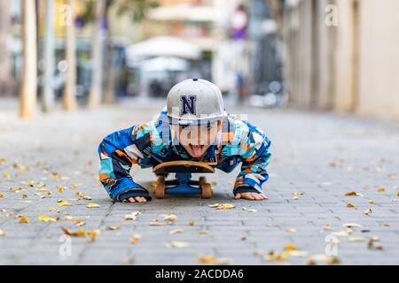 Cute little kid stretched on a skateboard Stock Photo