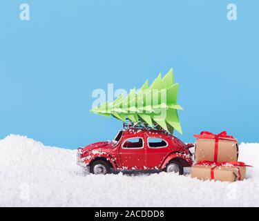 Close up of toy car Volkswagen Beetle with tree and Christmas presents Stock Photo