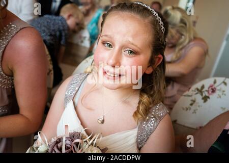 Beautiful bridesmaid trying at a tradition English indoor wedding ceremony at Floral Hall, Tunstall, Stoke on Trent, Wedding photography, celebration Stock Photo