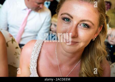 Beautiful bridesmaid trying at a tradition English indoor wedding ceremony at Floral Hall, Tunstall, Stoke on Trent, Wedding photography, celebration Stock Photo
