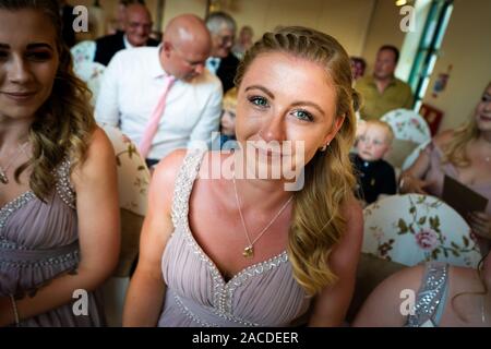 Beautiful bridesmaid trying at a tradition English indoor wedding ceremony at Floral Hall, Tunstall, Stoke on Trent, Wedding photography, celebration Stock Photo