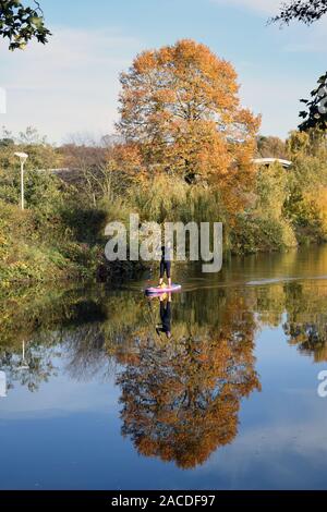 Woman paddleboarding on the River Wensum, Norwich UK November 2019 Stock Photo