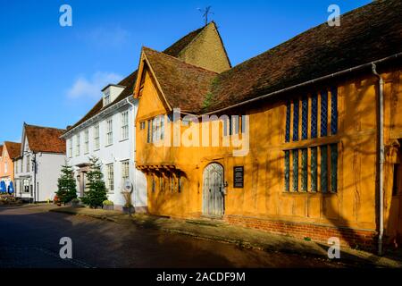 The orange painted Little Hall, which is a late 14th Century timber-famed house in the Market Place, Lavenham, Suffolk, England, UK Stock Photo