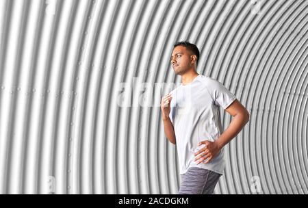 sporty young man running in tunnel Stock Photo