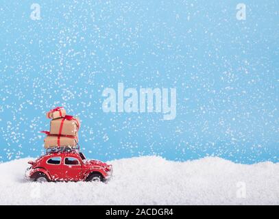 Creative Christmas background with toy retro car Volkswagen Beetle and presents Stock Photo