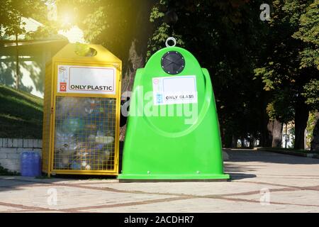 Separate garbage collection. Waste recycling in city concept. Containers for glass, plastic for further processing of garbage. Stock Photo