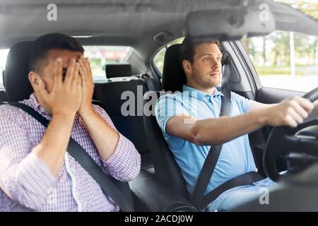 car driving school instructor and male driver Stock Photo