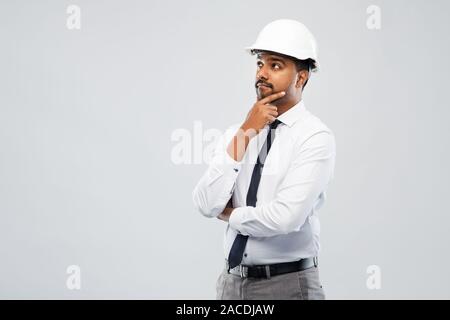 indian male architect in helmet over grey Stock Photo