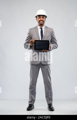 indian architect in helmet with tablet computer Stock Photo