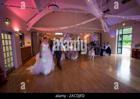 A gorgeous newly wed couple take to the dance floor short after taking their vowels and dedicating their lives to one another, the first dance Stock Photo