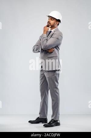 indian male architect in helmet over grey Stock Photo
