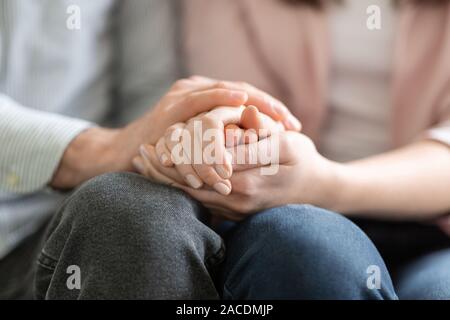 Man and woman holding each other hands, giving psychological support Stock Photo