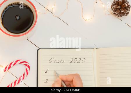 Top view of New Year Resolution goal list 2020 with Christmas decorations Stock Photo