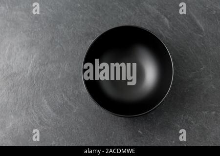 black ceramic plate on slate background Stock Photo