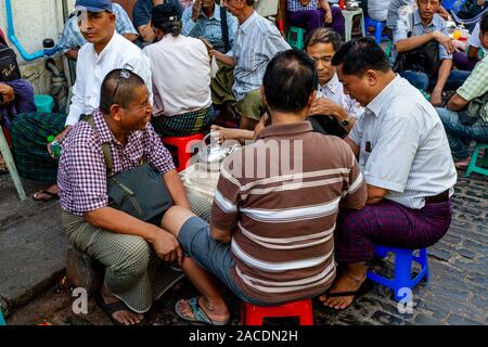 People Sitting Outside A Cafe Drinking Tea and Coffee In Bogyoke Aung San Market, Yangon, Myanmar. Stock Photo