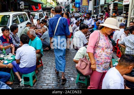 People Sitting Outside A Cafe Drinking Tea and Coffee In Bogyoke Aung San Market, Yangon, Myanmar. Stock Photo