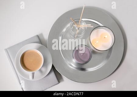 coffee, candles and aroma reed diffuser on table Stock Photo