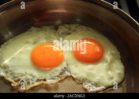 Two Delectable Sunny Side Up Eggs in a Frying Pan Stock Photo