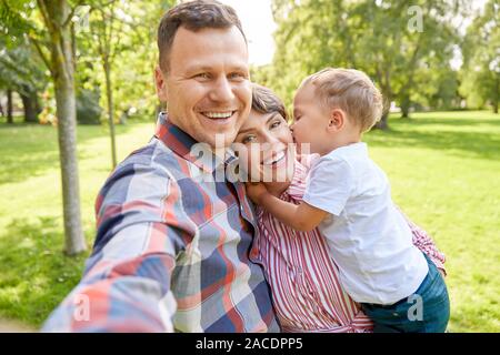happy family taking selfie at summer park Stock Photo