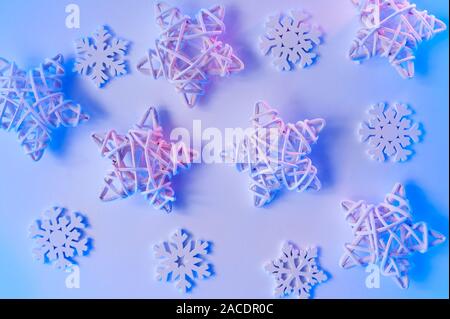 Christmas blue neon background with wooden stars and snowflakes. Holiday greeting card design with gradient lights Stock Photo