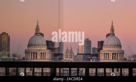 London, UK, 2nd Dec 2019. The dome of St Paul's Cathedral is reflected in a window. A beautiful sunset with clear skies concludes a cold but sunny day in London. Credit: Imageplotter/Alamy Live News Stock Photo