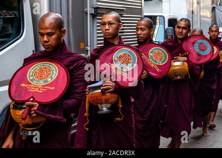 A Group Of Buddhist Monks Collecting Alms, Yangon, Myanmar. Stock Photo