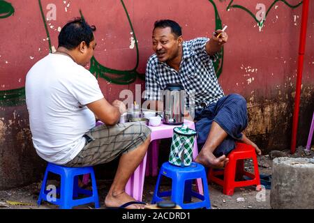 Two Men Drinking Coffee/Tea At A Street Cafe, Yangon, Myanmar. Stock Photo