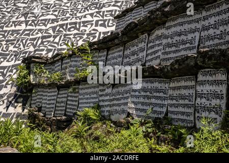 Big Mani Stones with the engraved tibetan mantra Om Mani Padme hum, located at the entrance of the village Stock Photo