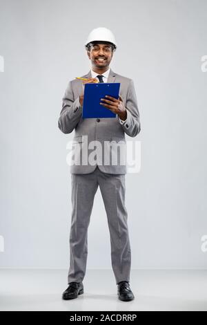 indian male architect in helmet with clipboard Stock Photo