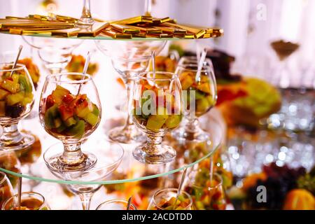 Fresh, exotic, organic fruits, light snacks in a plate on a buffet table. Assorted mini delicacies and snacks, restaurant food at event. Decorated del Stock Photo