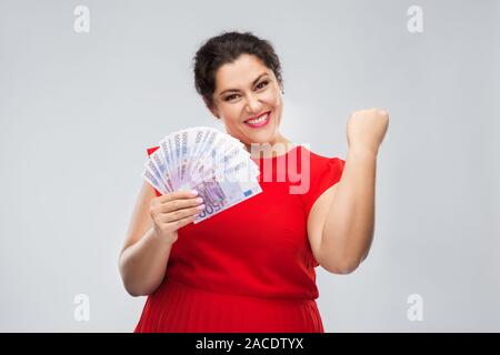 happy woman holding thousands of money banknotes Stock Photo