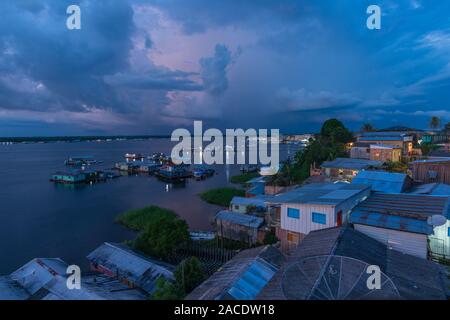 Twilight hour over the swimming houses on Lake Tefé, small town of Tefé on Solimoes River, Amazon State, Northern Brasilia, Latin America Stock Photo