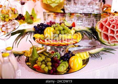 Fresh, exotic, organic fruits, light snacks in a plate on a buffet table. Assorted mini delicacies and snacks, restaurant food at event. Decorated del Stock Photo