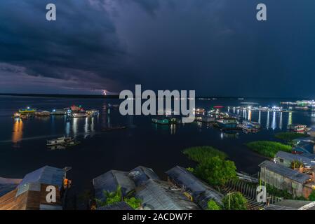 Flash and lightning over the swimming houses on Lake Tefé, small town of Tefé on Solimoes River, Amazon State, Northern Brasilia, Latin America Stock Photo
